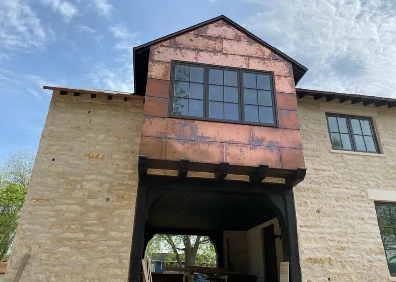 Copper metal panel facade on a stone building for Metal Roof Coating in Cave Springs